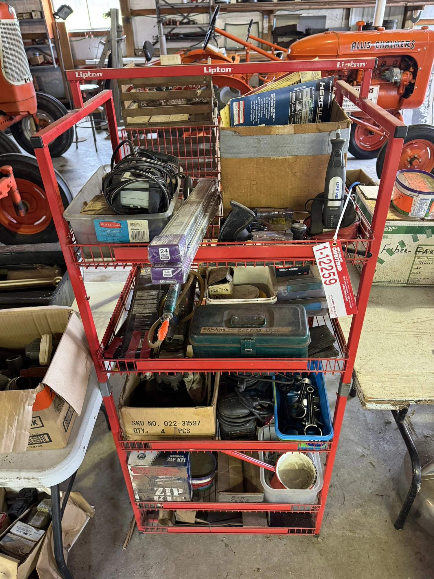 (1) small wire shelf with assorted contents, includes Dremel tool, small battery charger, pneumatic ...