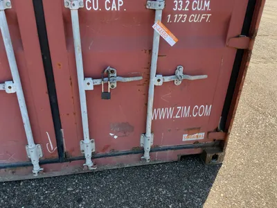 20’ Shipping / Storage Container 8’ wide x 8’ 6” tall, swing doors on one end, wood deck, rings for ...
