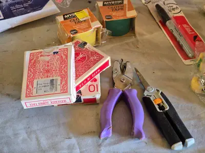 Assorted Office and Craft Supplies including Giant Pencil Decor, Cable Organizer, Glue Stic Foam Cushion Roll, and Miscellaneous Tools