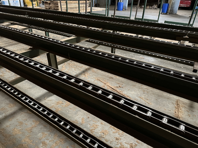 6 strand, 120' green chain with incoming deck and hoist. 24 heavy duty carts