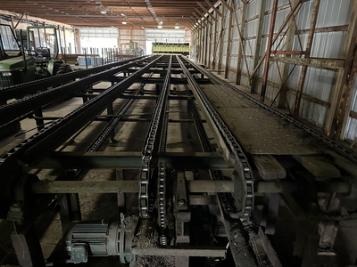 6 strand, 120' green chain with incoming deck and hoist. 24 heavy duty carts