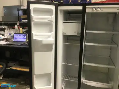 USED GE STAINLESS STEEL AND BLACK SIDE X SIDE REFRIGERATOR HEAVY DUTY ENERGY STAR
